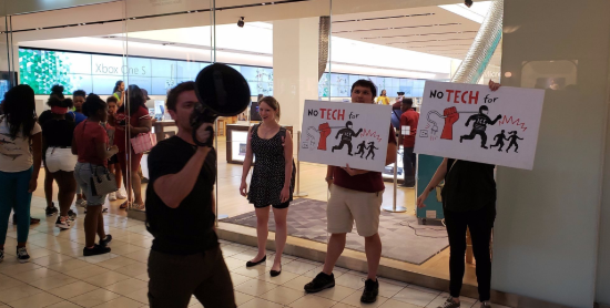 Protesters hold up signs saying 'No tech for ICE' Protesters hold up signs saying 'No tech for ICE'