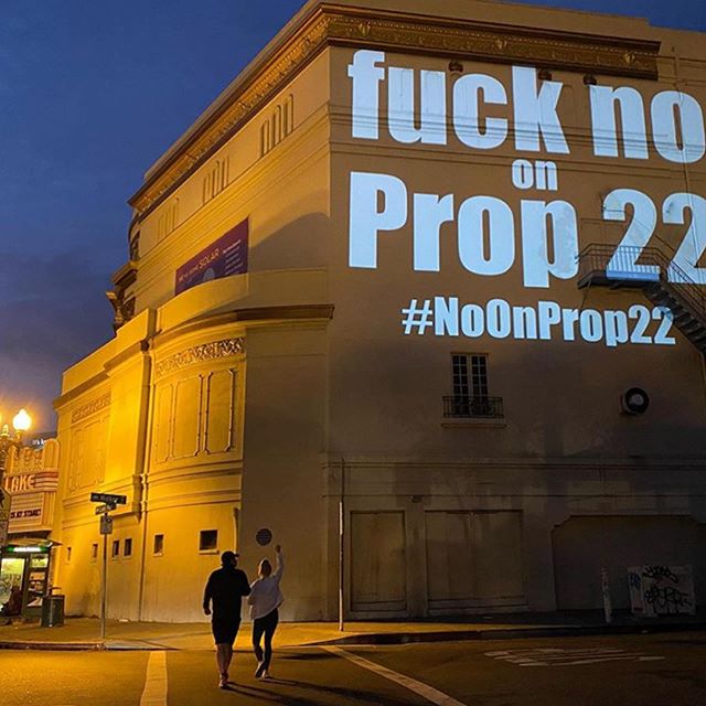 Fuck No on Prop 22 projected on the side of a building. Fuck No on Prop 22 projected on the side of a building.