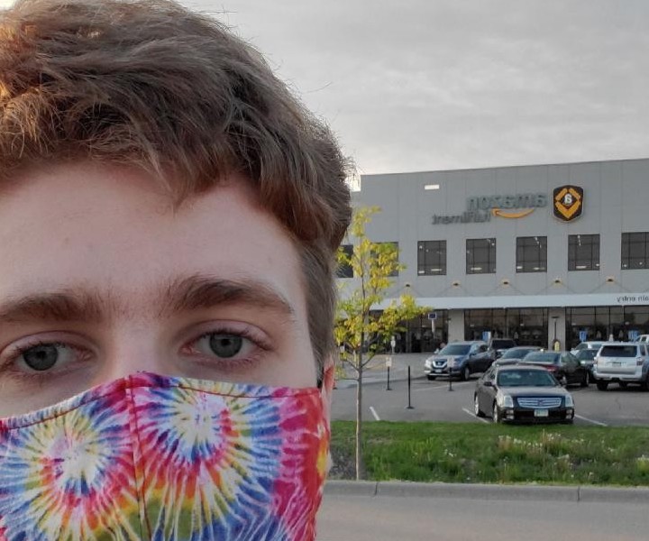 Amazon worker appearing in front of warehouse speaking about employer retaliation. Amazon worker appearing in front of warehouse speaking about employer retaliation.