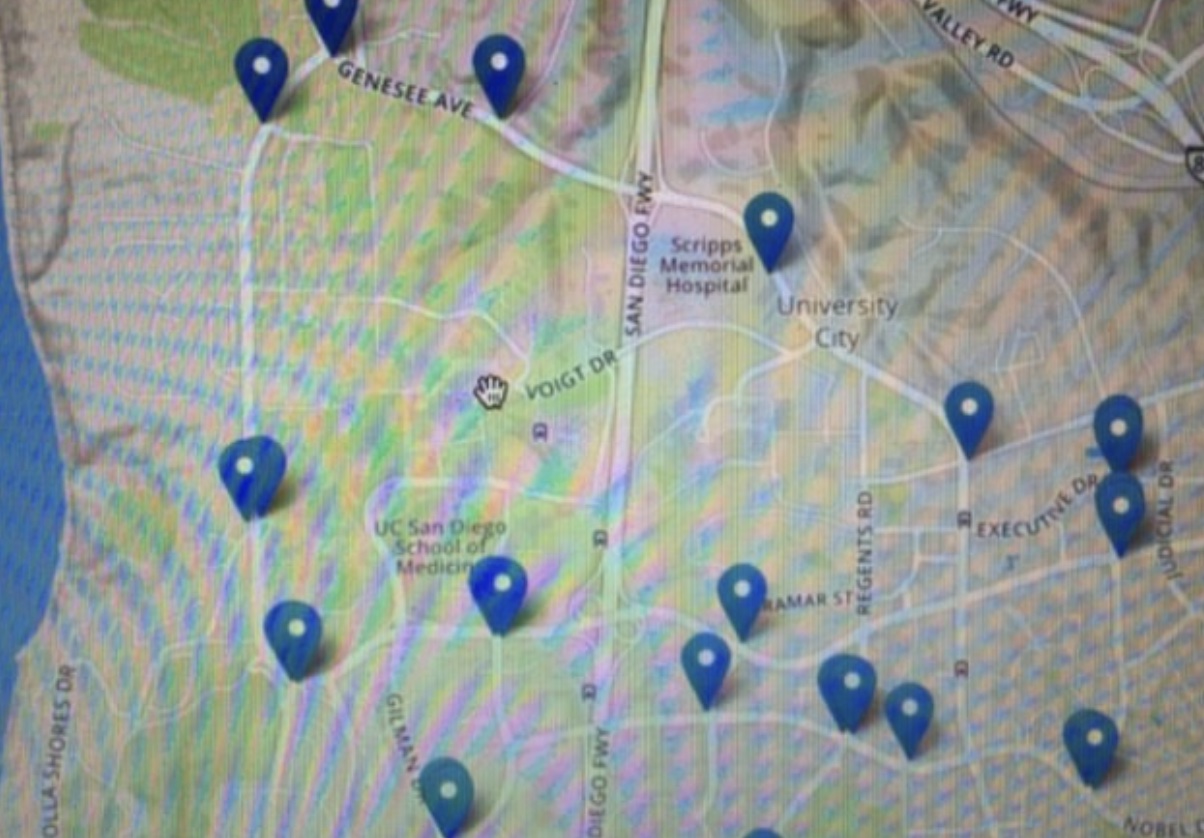 Image of a map with a dozen blue pins on it Image of a map with a dozen blue pins on it
