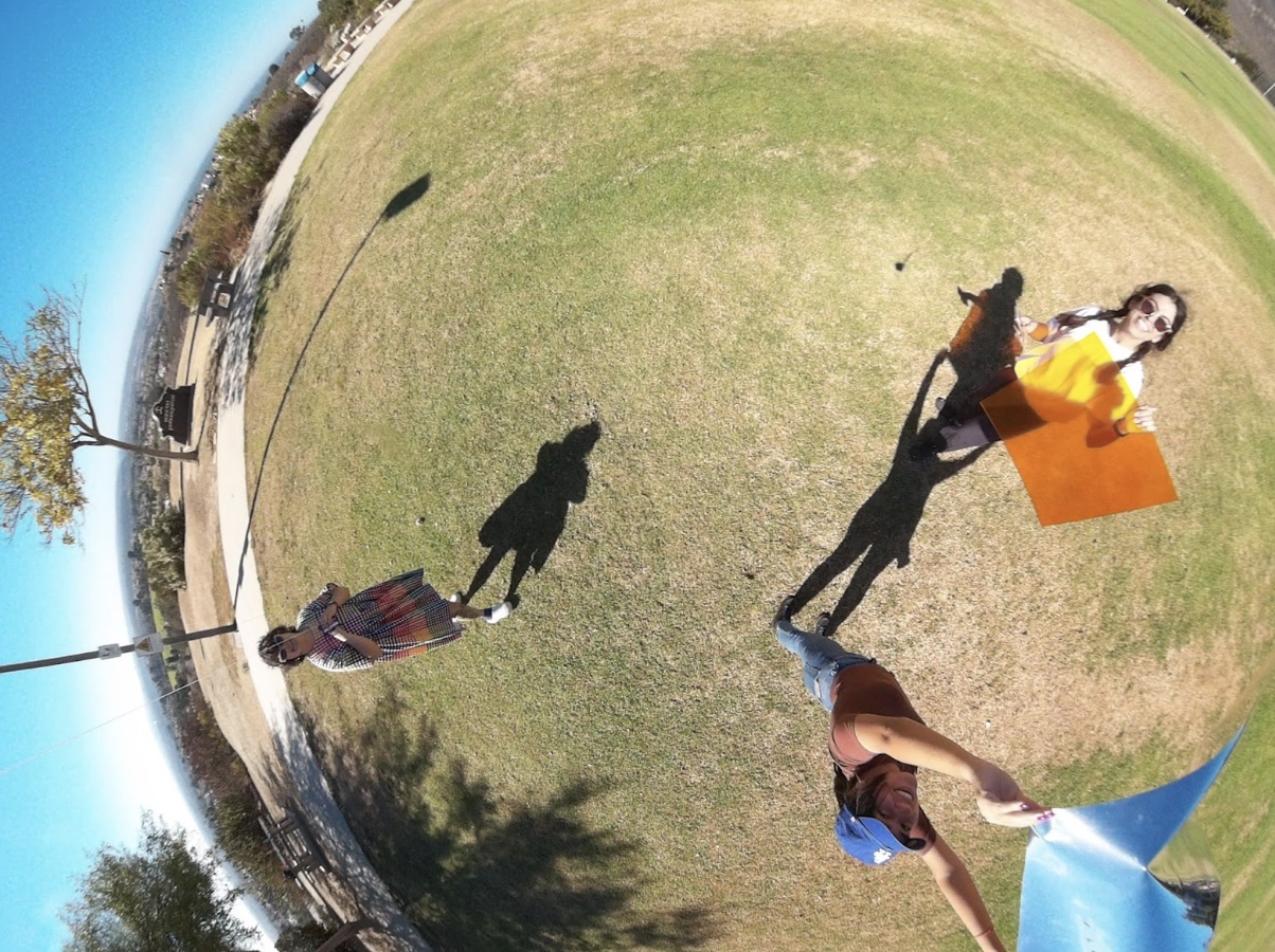 Katie Giritlian, Maria Antonia Eguiarte and Arlene Mejorado take a group photo, smiling up at the kite camera. Katie Giritlian, Maria Antonia Eguiarte and Arlene Mejorado take a group photo, smiling up at the kite camera.