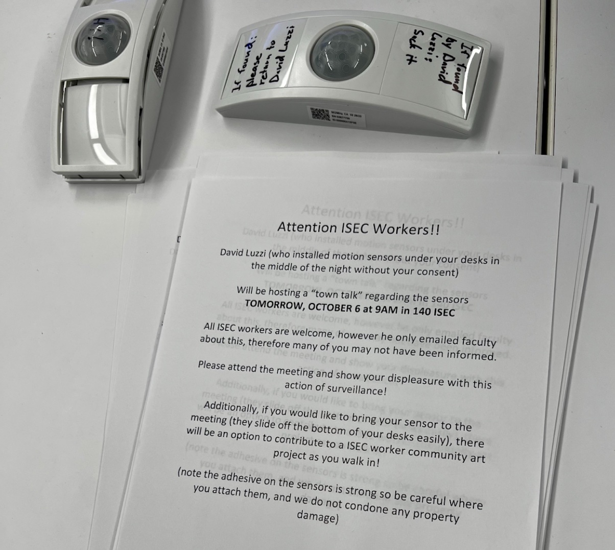 two previosly installed sensors next to a notice with a call to action for students to remove them two previosly installed sensors next to a notice with a call to action for students to remove them