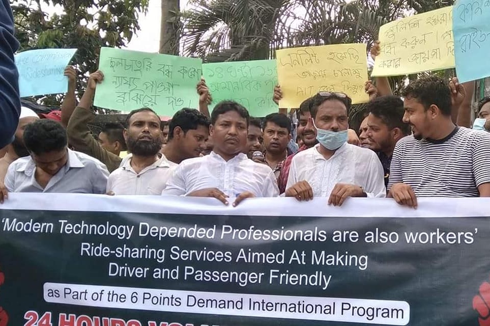 A photo of dozens of drivers marching with a banner that reads, Modern Technology Depended Professionals are also workers - and a list of six demands A photo of dozens of drivers marching with a banner that reads, Modern Technology Depended Professionals are also workers - and a list of six demands